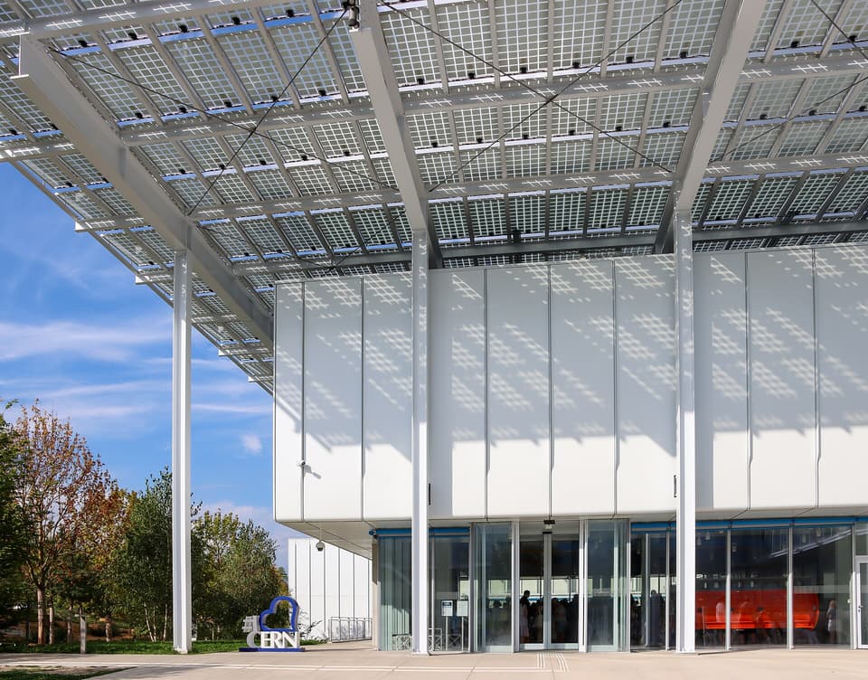 L'entrée du Science Gateway du CERN à Meyrin, bâtiment de Renzo Piano sous un grand toit de panneaux solaires, avec le logo «&nbsp;I love CERN&nbsp;» sur le parvis