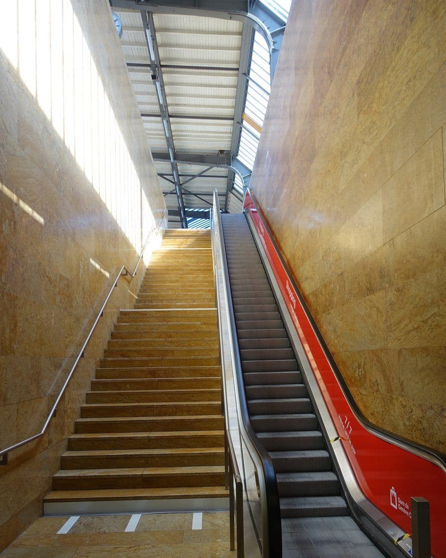 Quai de la gare de Genève-Cornavin avec un train régional et des voyageurs, sous la grande verrière