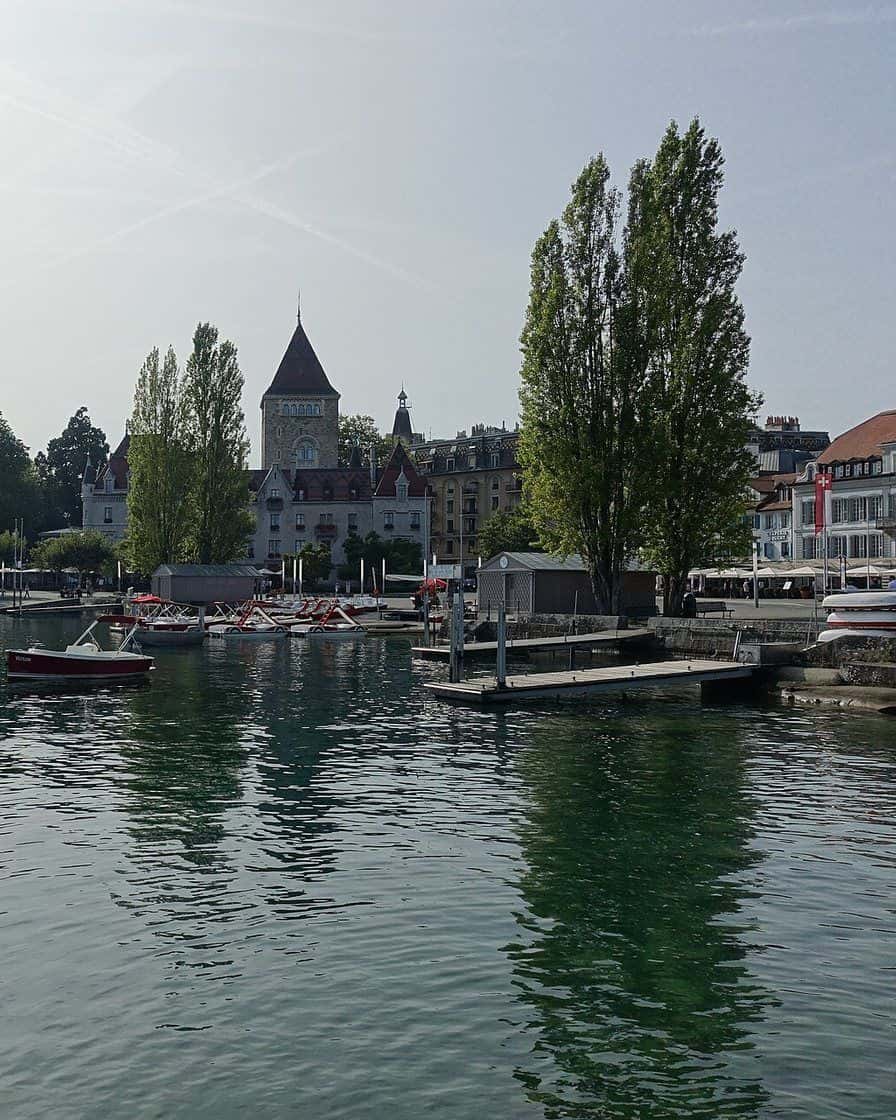 Le port d'Ouchy à Lausanne, ses quais et ses bateaux au bord du lac Léman, avec les Alpes de Haute-Savoie en face